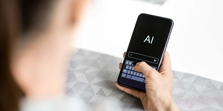 Person using a smartphone with AI software on the screen, symbolizing technology tools for modern job searching and applications.